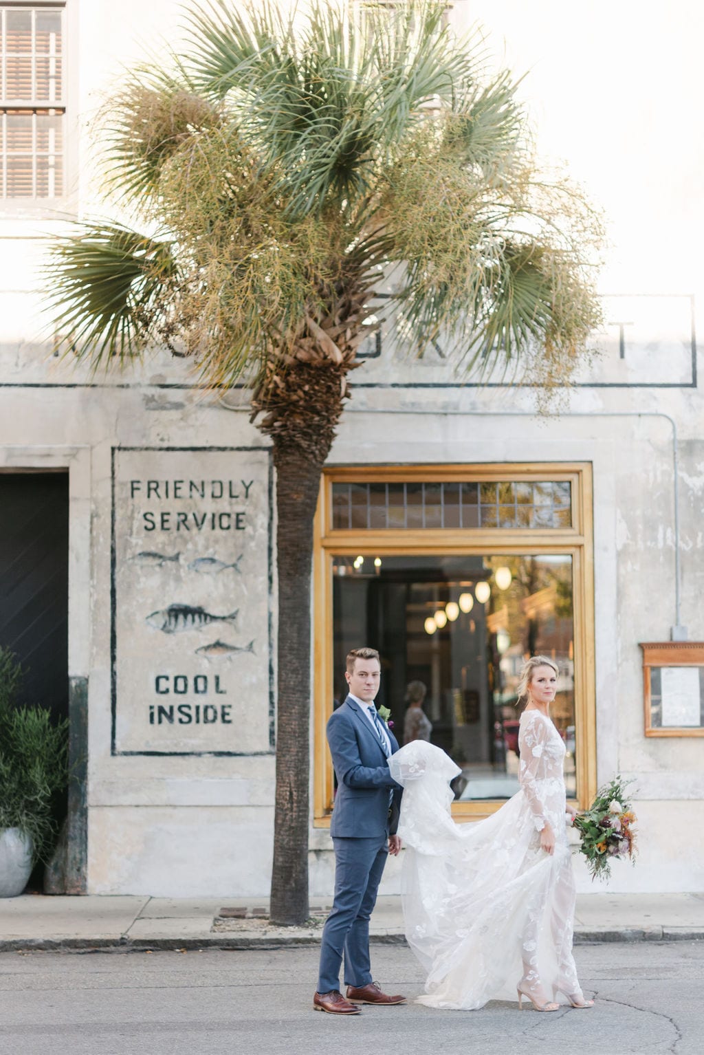 Bride and groom standing outside on downtown Charleston streets, for their portrait shots after their Charleston elopement.