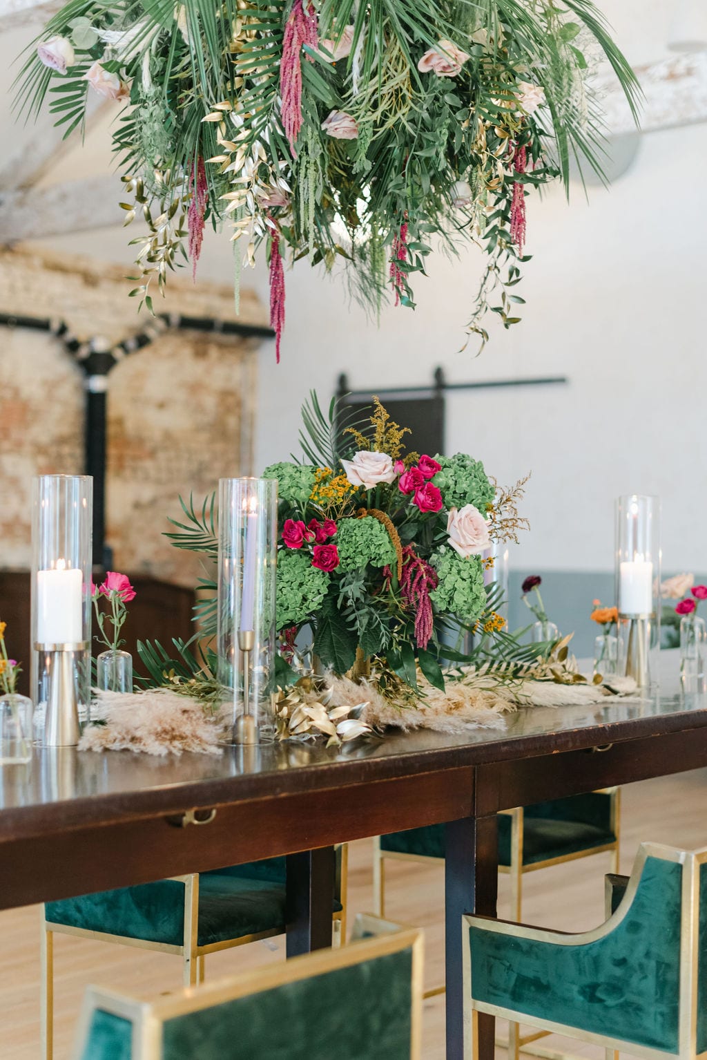 Charleston elopement reception design, with palms, emerald green bar stools, and candle accents.
