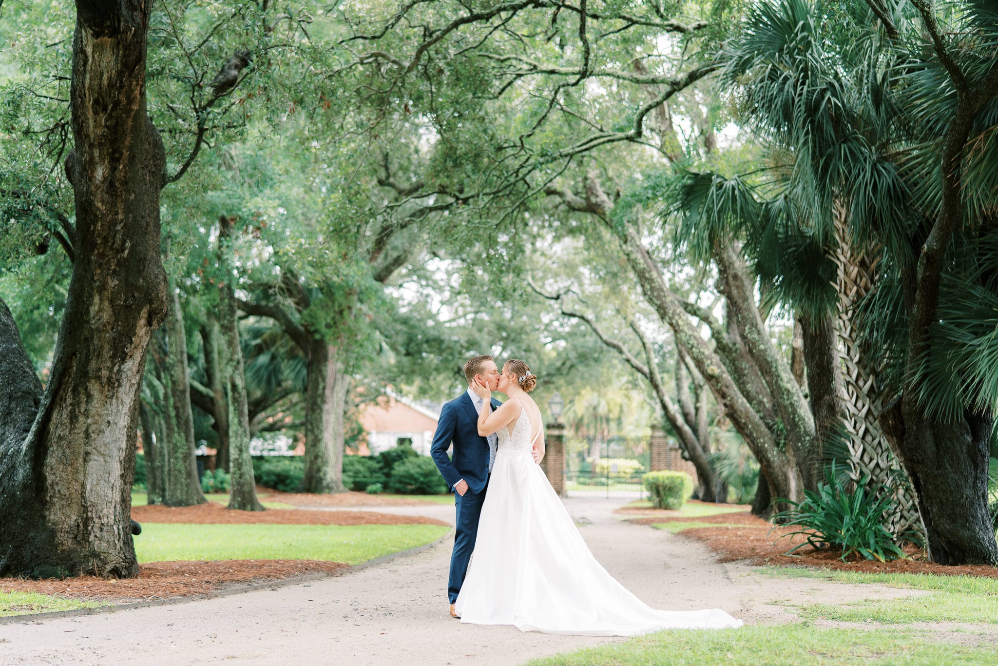 Beautiful bride and groom kissing on their intimate wedding day at Lowndes Grove